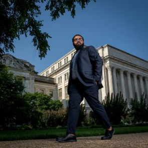 man in suit walking outside
